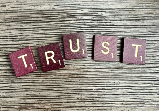 scrabble tiles building the word trust