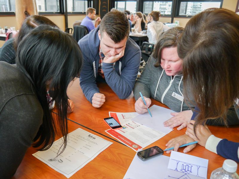 group of people playing code break at a table