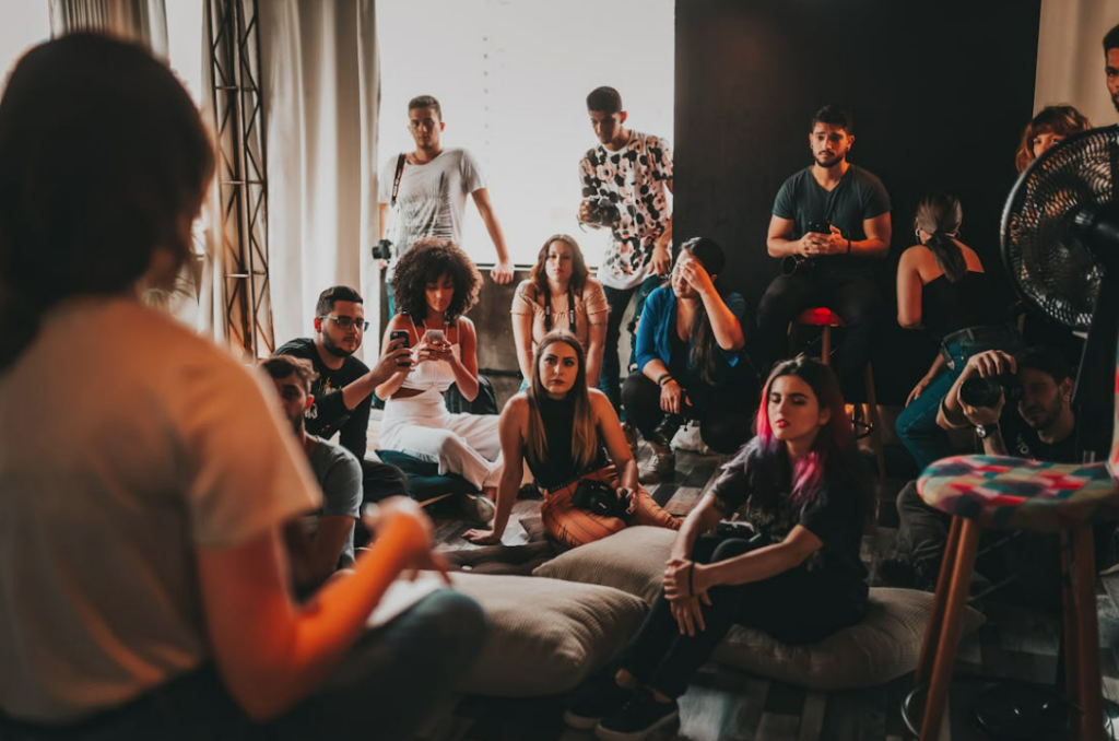 group of people gathered in a room listening to a speaker