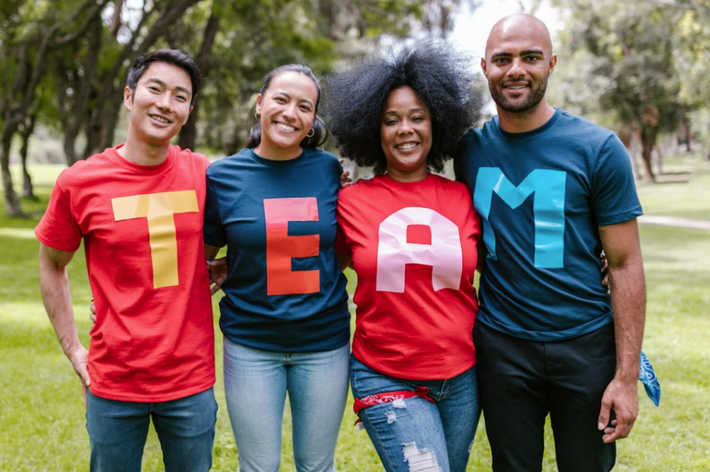 group of 4 people with shirts that spell out TEAM